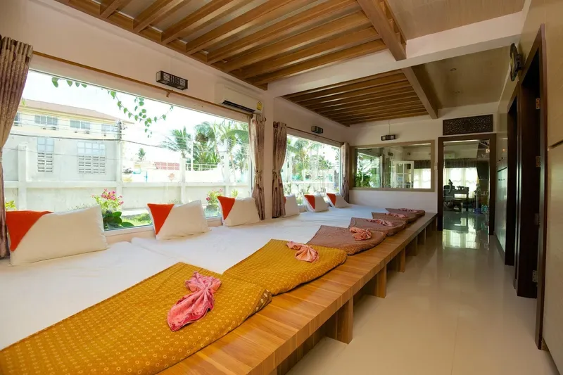 Thai massage room with mattresses and silk cushions